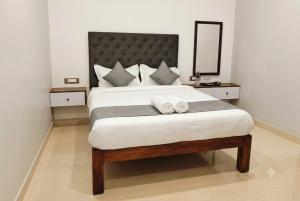 a bedroom with a large bed with two towels on it at L2 Retreat in Kottakupam +7 photos