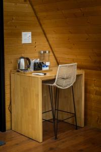 a wooden counter with a chair in a room at The Arks Baagh Villas in Rāmnagar