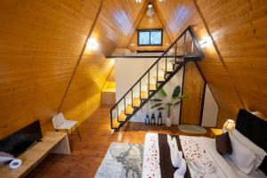 an attic room with a staircase in a house at The Arks Baagh Villas in Rāmnagar