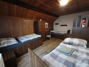 a room with three beds and a table and chairs at Apartmány ŠTĚSTÍ in Bechlín
