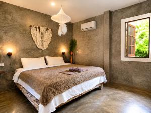a bedroom with a large bed and a window at The Verandas in Hinkong