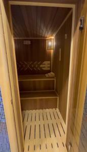 a walk in closet with a door open at A-Frame Pool & Spa in Baku
