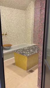a bathroom with a tub in a room with tiles at A-Frame Pool & Spa in Baku