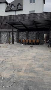 an outdoor patio with a cord on the ground at A-Frame Pool & Spa in Baku