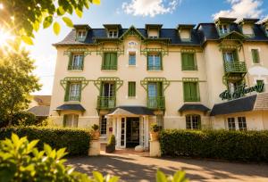 a building with green shutters on it at Hôtel Villa Flornoy Pornichet Baie de la Baule in Pornichet