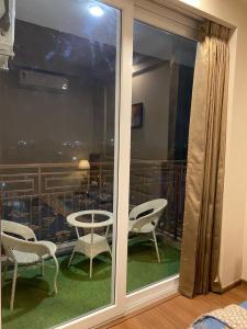 a view of a balcony with chairs and a table at Max Stays in Greater Noida