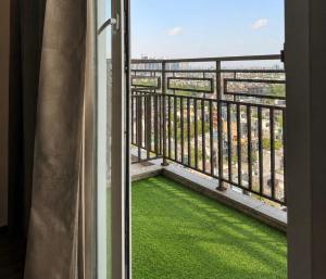 a balcony with a view of the ocean at Max Stays in Greater Noida