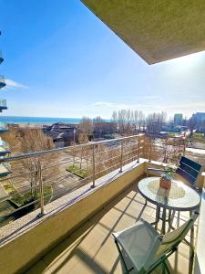a balcony with a table and a view of the ocean at Summerland Seaview Premium Apartments in Mamaia