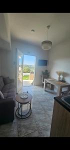 a living room with a couch and a table at Alma-Libre house 2 in Kefalos