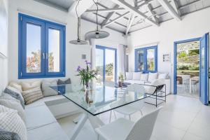 a living room with a glass table and chairs at Villa Aless in Skopelos Town