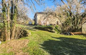 a grassy yard with a house in the background at Harmant Gîte Au Calme in Saint-Maigrin +7 photos