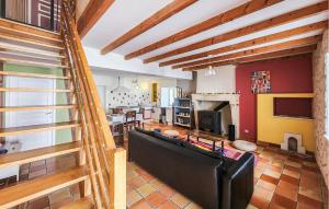 a living room with a couch and a kitchen at Harmant Gîte Au Calme in Saint-Maigrin
