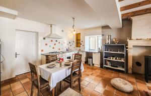 a kitchen with a table and chairs and a stove at Harmant Gîte Au Calme in Saint-Maigrin