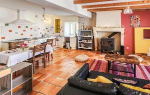 a kitchen and living room with a couch and a table at Harmant Gîte Au Calme in Saint-Maigrin