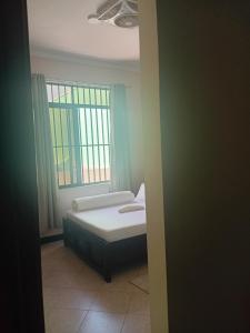 a bedroom with a bed and a window at Ponte Vedra Lodge in Mwanza +9 photos