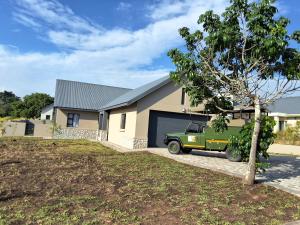 a green truck parked in front of a house at Natures Nest with Mongi Hazyview in Hazyview