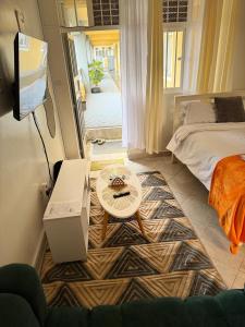 a room with a bed and a table and a tv at Tulivu Homes in Meru +4 photos