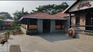 a building with a sign on the side of it at Ashoka Resort in Wai