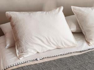 a white pillow sitting on top of a bed at Blanca Martín in Trevélez