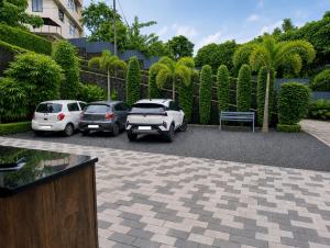 a group of cars parked in a parking lot at Easy Nest Residency in Kannur
