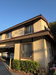 a building with a car parked in front of it at Palm Cabin in San Gabriel