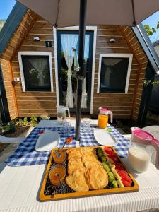 a tray of food on top of a table at Koman Twin Cabins in Gushtë