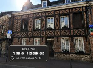 a building with a sign in front of it at Gite Normandie in Forges-les-Eaux