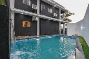 a swimming pool in front of a house at II JAGUAR VILLA lI in Lonavala