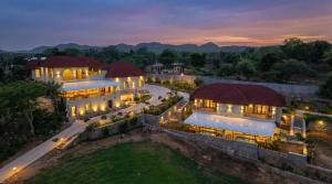 an aerial view of a mansion at night at Aamba Bagh Resort Kumbhalgarh in Kumbhalgarh