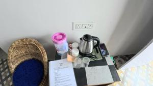 a table with a coffee maker on top of it at Nini's Homestay, Kalimpong in Pedong