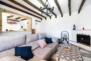 a living room with a couch and a fireplace at VillaHaba BarrosaHome in Novo Sancti Petri