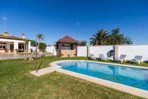 a swimming pool in the yard of a house at VillaHaba BarrosaHome in Novo Sancti Petri