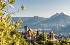 a view of a city with mountains in the background at Ferienwohnungen Preiss - Schenna in Schenna +14 photos