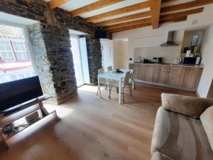 a living room with a couch and a table at O Recuncho de Mugardos in Mugardos +2 photos