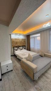 a large bedroom with a large bed and a couch at PERLA SUİTES hotel in Istanbul