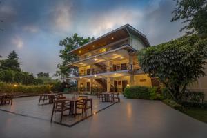 a building with tables and chairs in front of it at Summit Norling Resort & Spa in Gangtok +37 photos