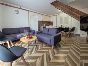 a living room with blue couches and a table at Vila Vidovic Drina in Bajina Bašta