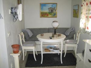 a living room with a table and a couch at Fårö stonehouse in Fårö +6 photos