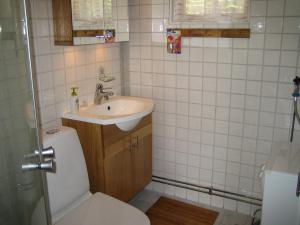 a small bathroom with a toilet and a sink at Fårö stonehouse in Fårö
