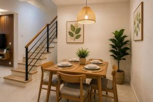 a dining room with a wooden table and chairs at 2BR Sunset View House in Coron Town Proper in Coron