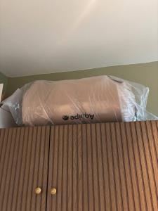 a bed with a plastic bag on top of it at 2BR Sunset View House in Coron Town Proper in Coron +1 photo