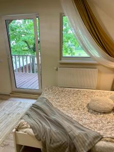 a bedroom with a bed and a large window at Tamme maja - Oak Tree House with big terrace and balcony in Tapa