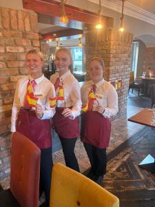 a group of three women in a restaurant wearing ties at Arnolds Hotel in Dunfanaghy