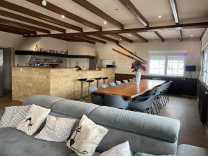 a living room with a couch and a wooden table at Gîtes BEL'M in La Bresse