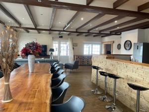 a bar with a row of stools in a room at Gîtes BEL'M in La Bresse +79 photos