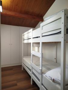 a white bunk bed in a room with wooden ceilings at Sweet November in Valencia