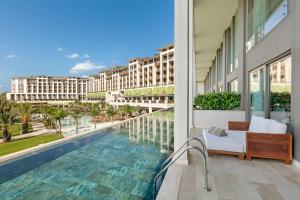 a view from the balcony of a hotel with a swimming pool at Cullinan Belek in Belek