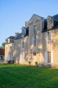 a large house with a green lawn in front of it at Château de Saint Clair in Saint-Clair-sur-lʼElle