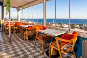 a restaurant with tables and chairs and a view of the ocean at Sultanahmet Nu Hotel in Istanbul