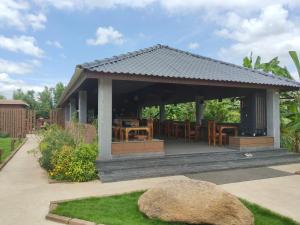 a gazebo with a table and chairs at Tutti Cafe in Hampi